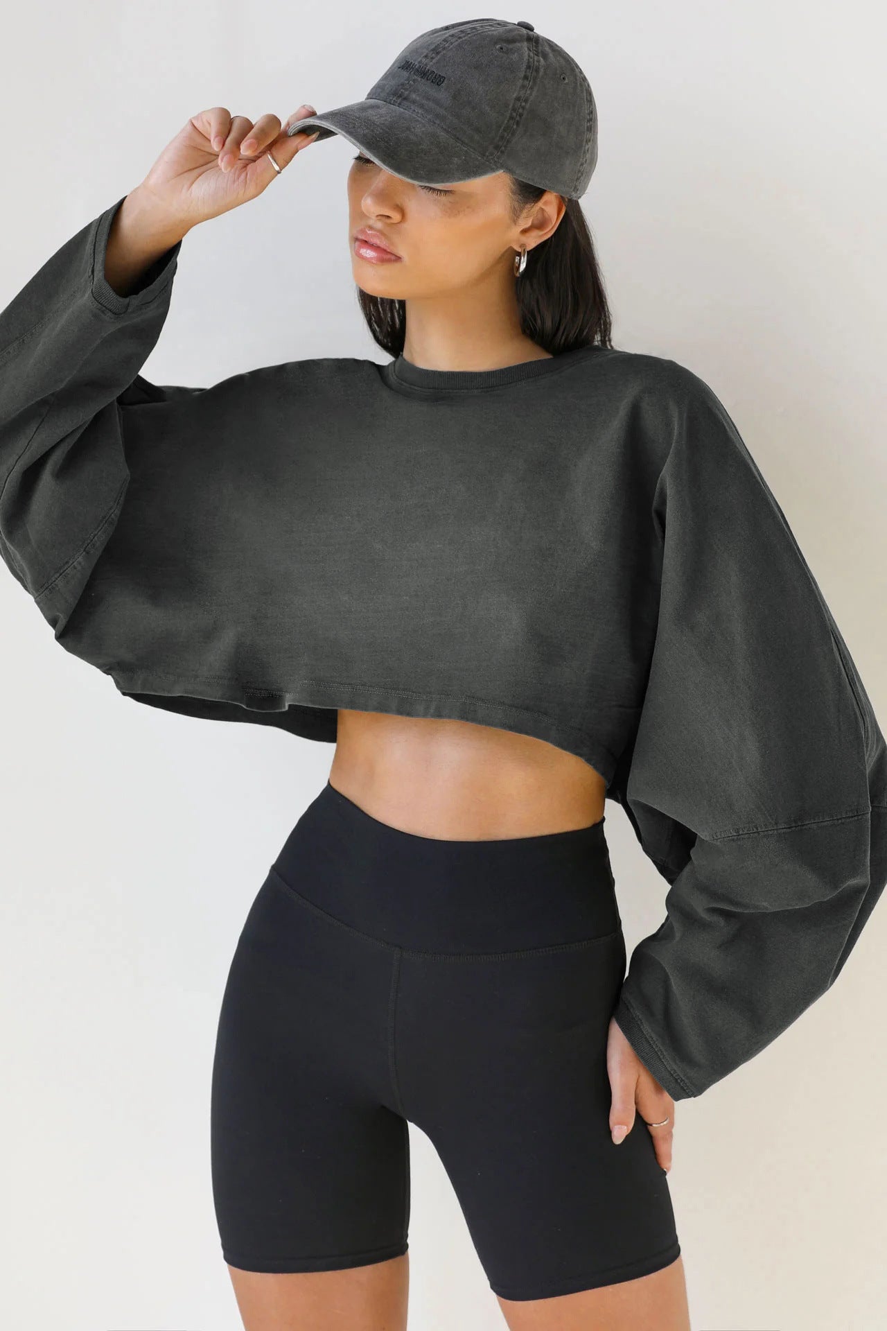 Crop Sweatshirt with Balloon Sleeves in Washed Neutrals - dark grey front view with bike shorts