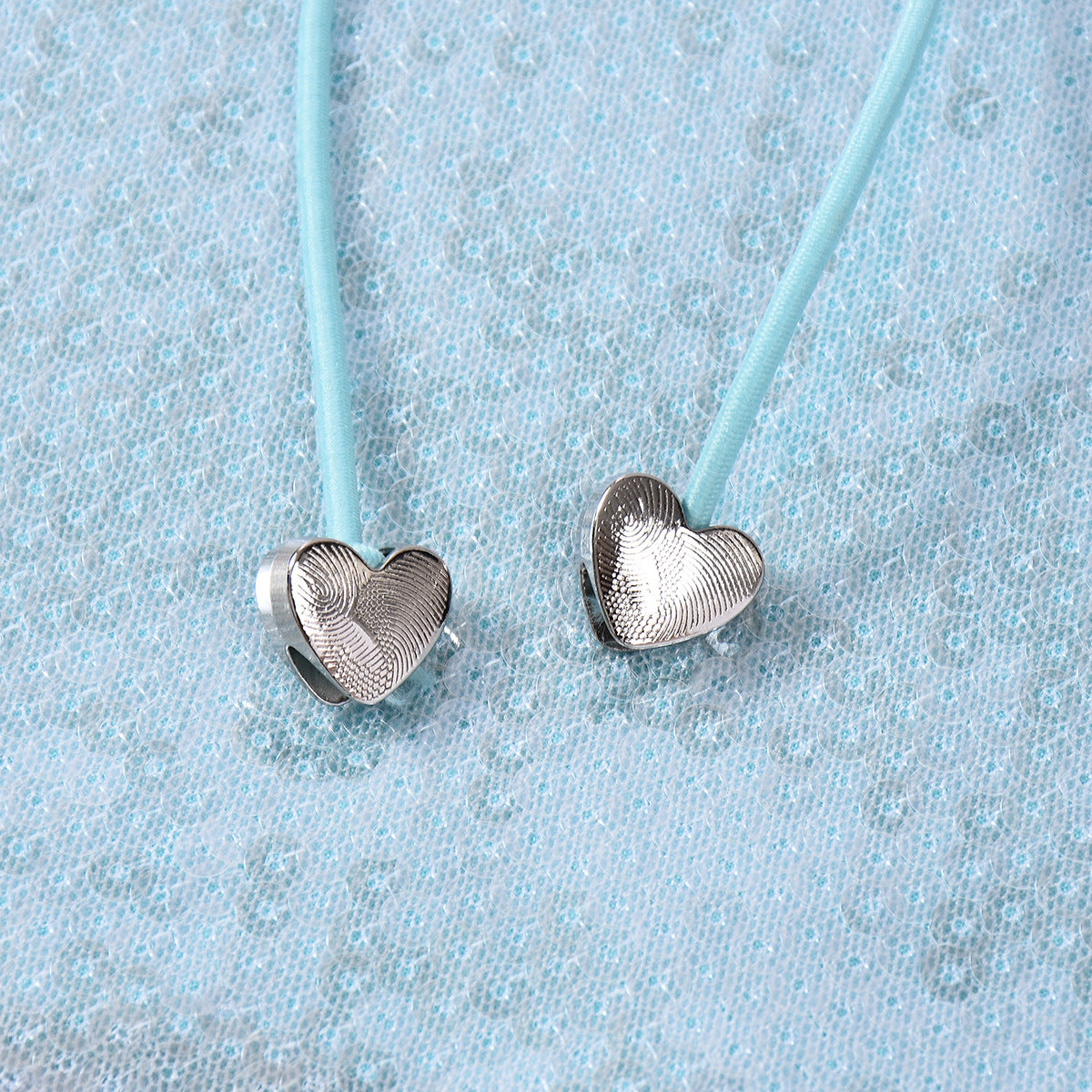 Sleeveless Top in Mint Green & Black with Sequin Cut-Out and Beaded Tie - mint green heart bead tie close-up