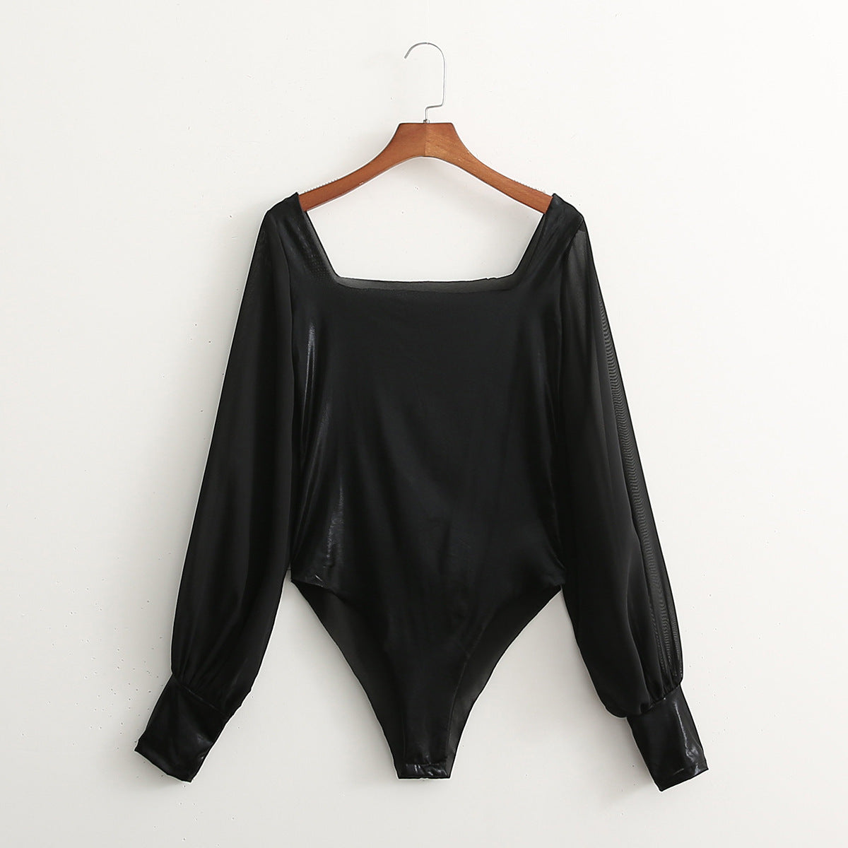 Bodysuit in Black Faux Leather with Sheer Sleeves - black flat lay front view