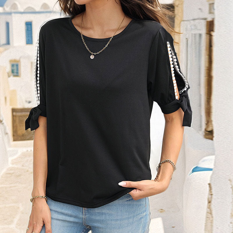 T-Shirt in Black with Pearl-Trim Cold-Shoulder Sleeves - black front view tucked into jeans