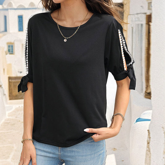 T-Shirt in Black with Pearl-Trim Cold-Shoulder Sleeves - black front view tucked into jeans