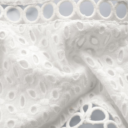 Cami Crop Top in White Broderie Anglaise - white close-up of the broderie anglaise texture and circular hem trim
