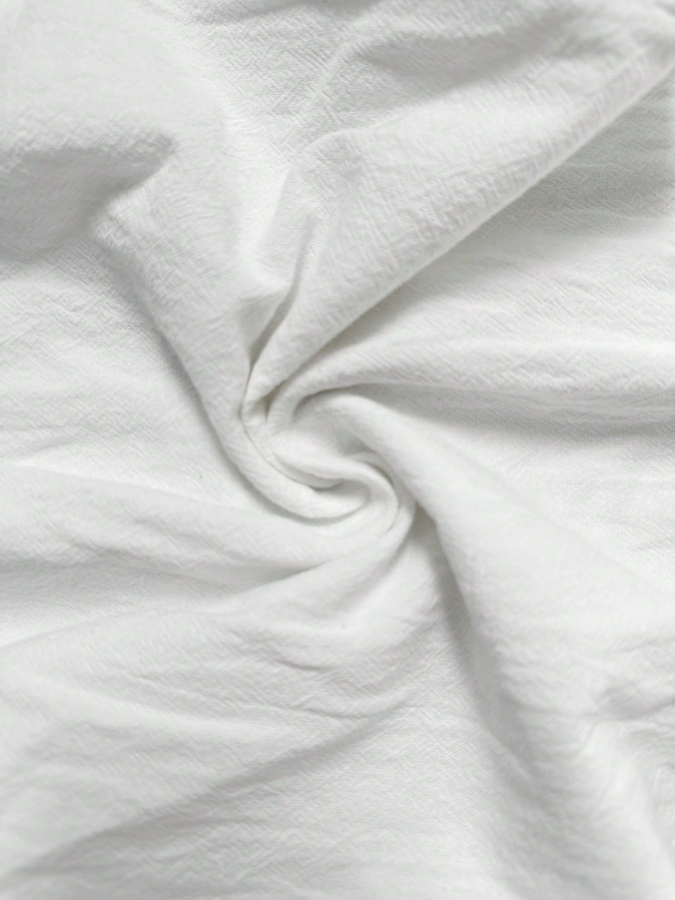 Wide-Leg Trousers in White Crinkle Cotton - white crinkle cotton texture close-up