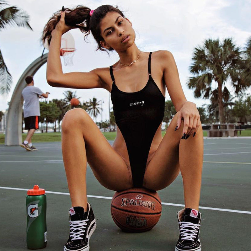 Bodysuit in Black with Slogan Front and High-Cut Sides - black full-body view on basketball court