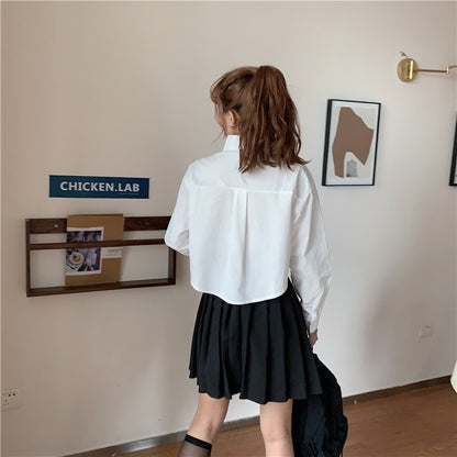 Shirt in White with Cropped Boxy Fit - white back view with black pleated skirt