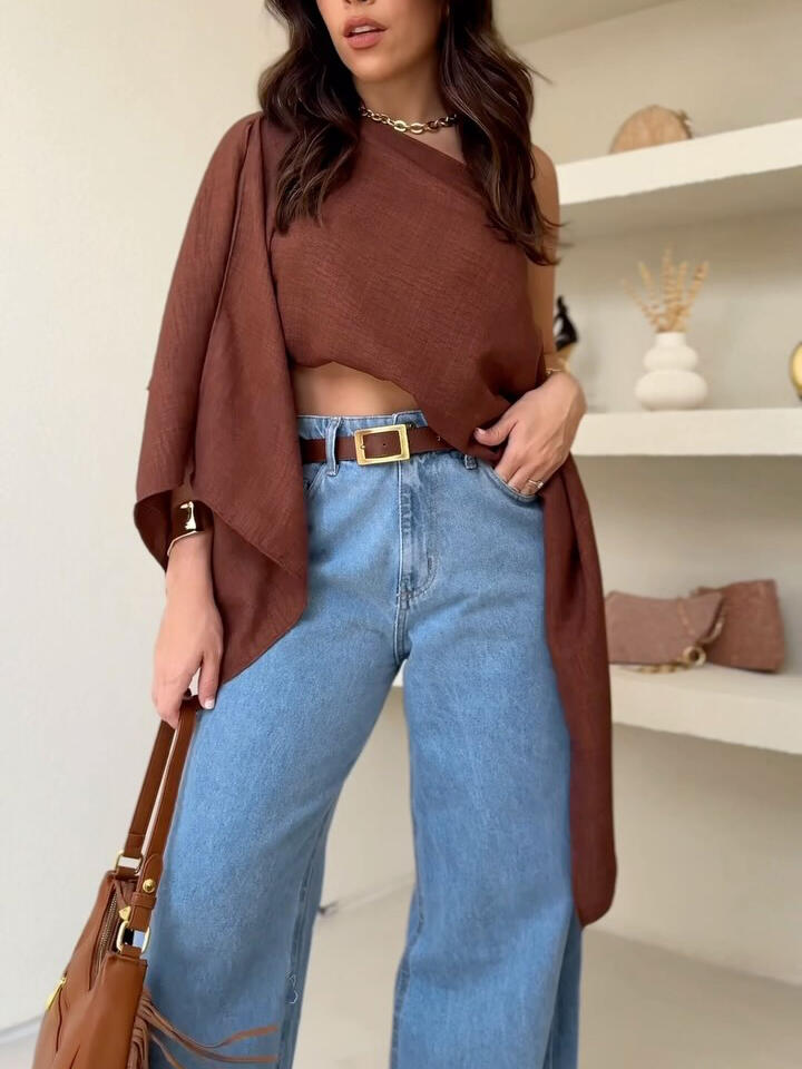 Brown Asymmetric One-Shoulder Drape Top — front view styled with light blue jeans and brown belt
