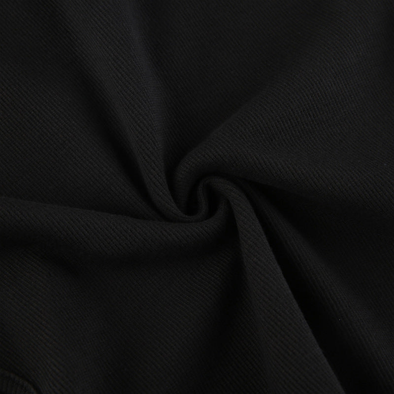 Bodysuit in Black with Shoulder Cut-Outs & Arm Warmers - black ribbed fabric close-up