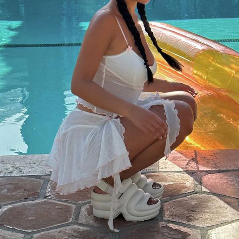Mini Skirt in White with Pleated Mesh Overlay - side seated view