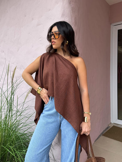 Brown Asymmetric One-Shoulder Drape Top — outdoor lifestyle shot showing the bare-shoulder side