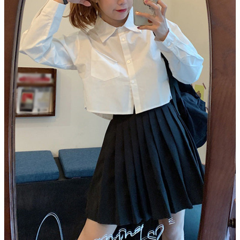 Shirt in White with Cropped Boxy Fit - white front mirror view with black pleated skirt