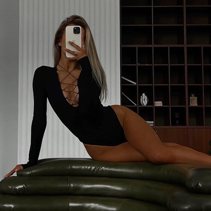 Bodysuit in Black with Long Sleeves and Lace-Up Plunge Neck - black full-length lounging angle